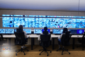 Modern industrial SCADA control room with operator workstations and live data monitoring screens.