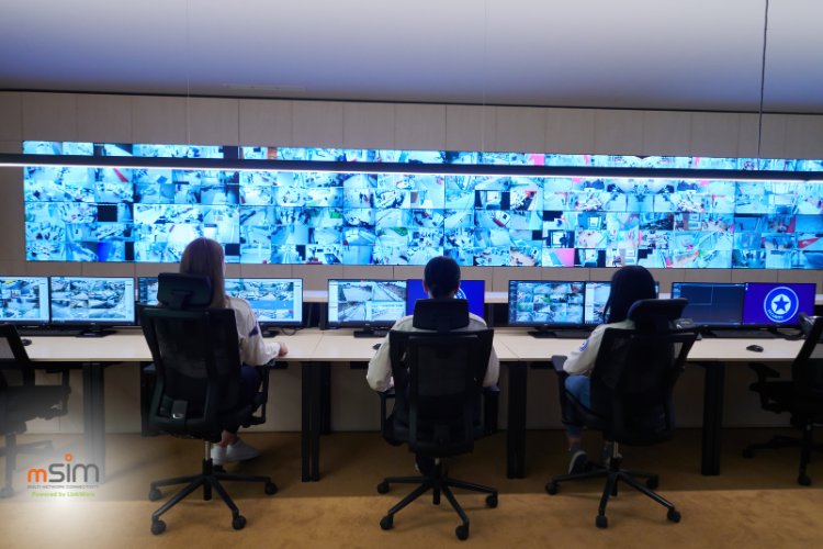 Modern industrial SCADA control room with operator workstations and live data monitoring screens.
